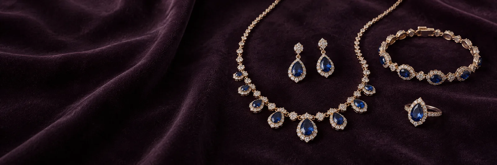 Blue-colored coordinated jewelry on plum velvet, collection inspiration
